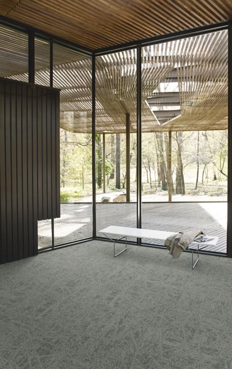 Interface Open Air 419 carpet tile in corner space with coat draped over small white bench and wooden slat ceiling