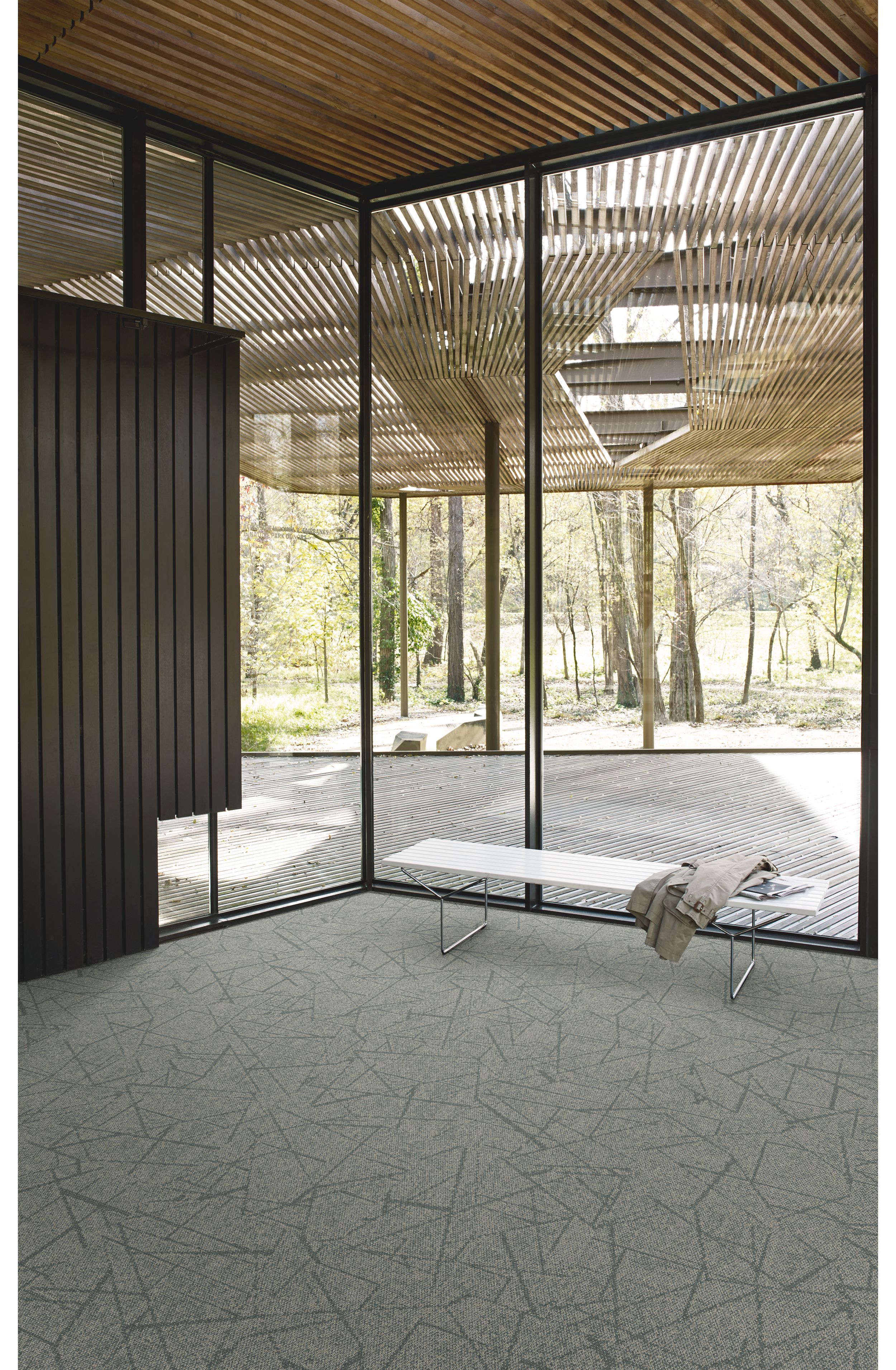 Interface Open Air 420 carpet tile in corner space with small white bench and wooden slat ceiling image number 2