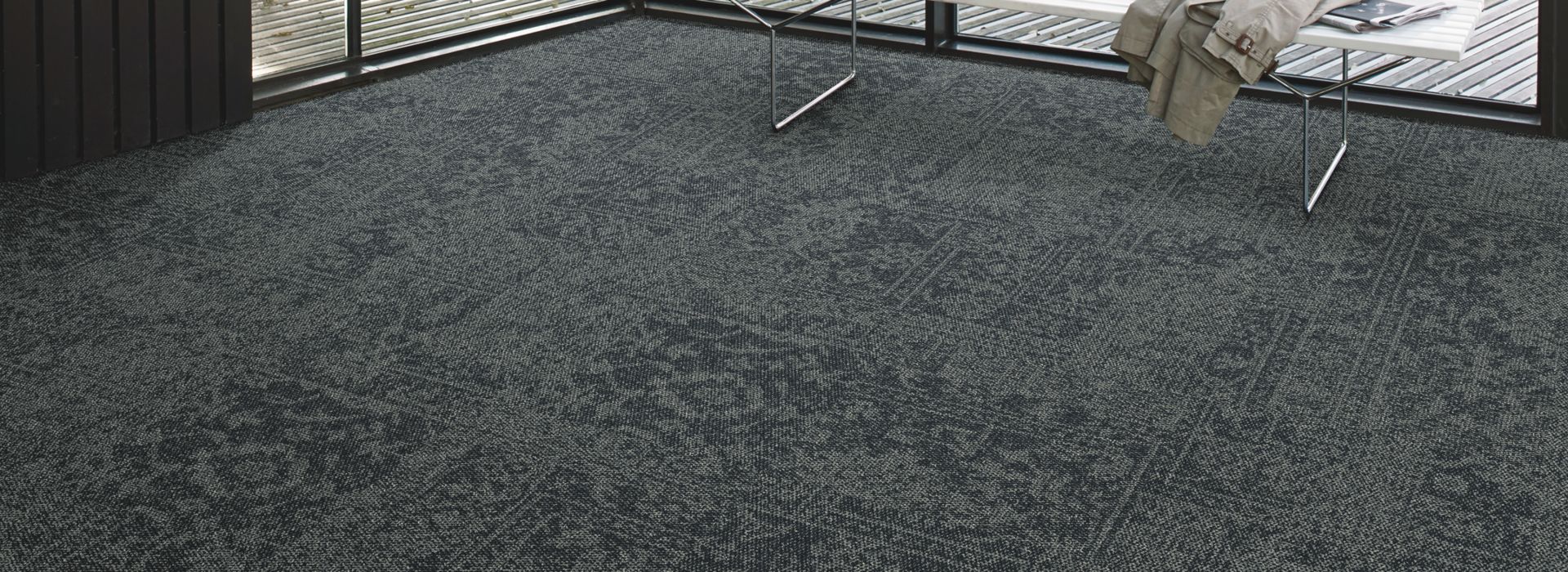 Interface Open Air 421 carpet tile in corner space with small white bench and wooden slat ceiling