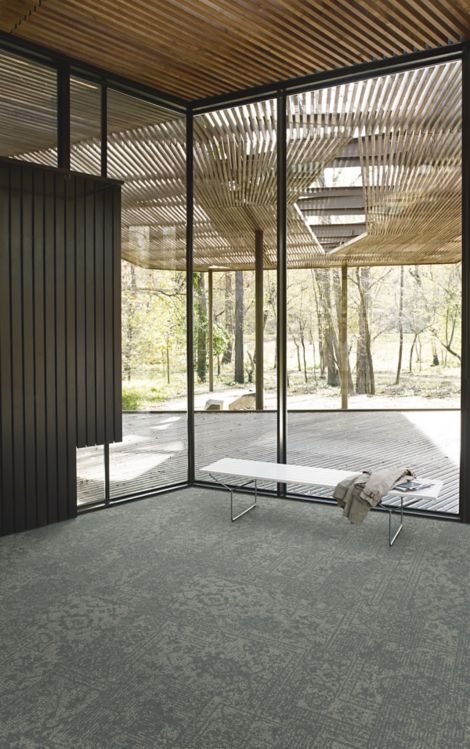 Interface Open Air 421 carpet tile in corner space with small white bench and wooden slat ceiling