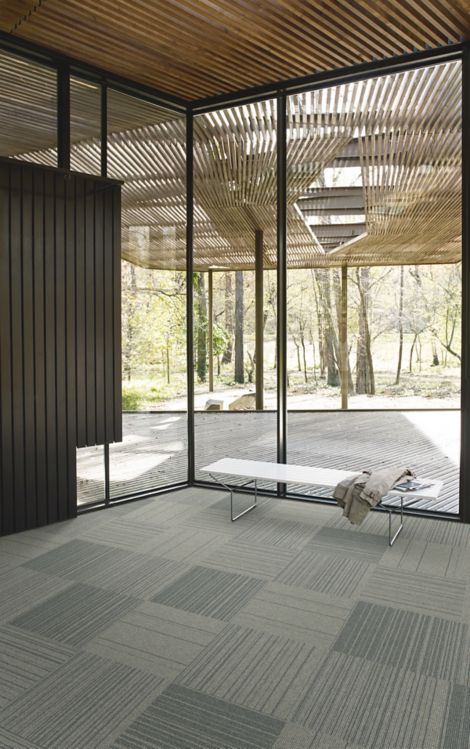 Interface Open Air 423 carpet tile in corner space with small white bench and wooden slat ceiling