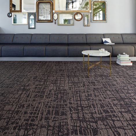 Interface WE153 plank carpet tile in lobby area with long couch, small white table and arrangement of mirrors on wall image number 4
