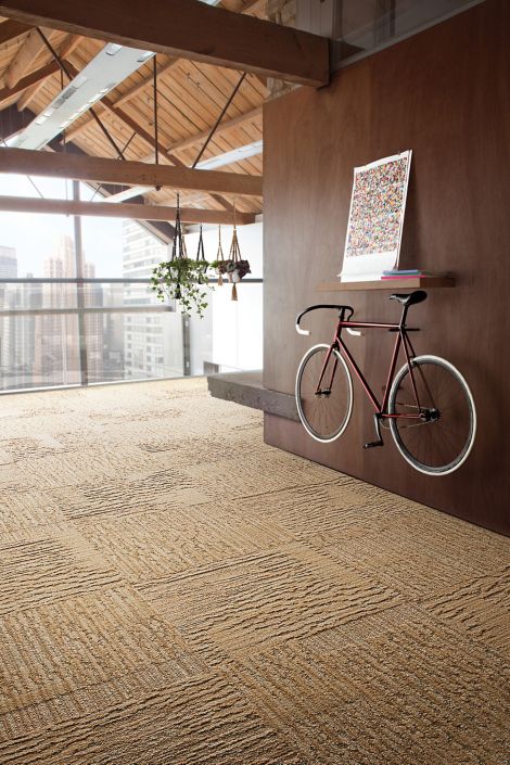 Interface UR201 carpet tile in office corridor with wood walls and bicycle on wall