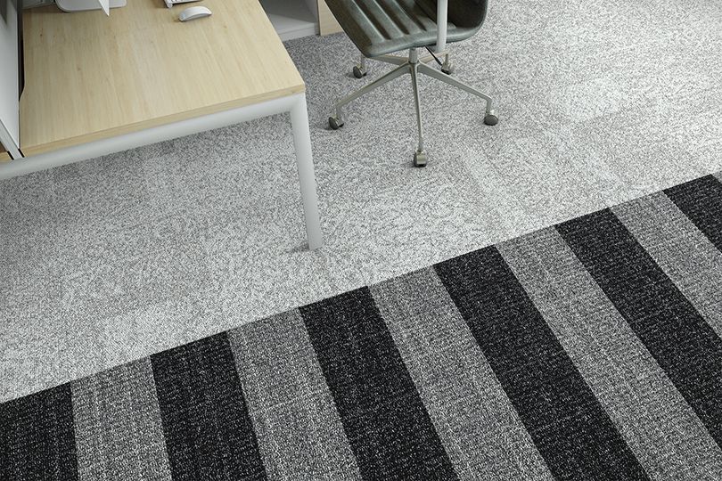 Interface Open Air 405 carpet tile in overhead view with wooden desk and leather rolling chair image number 6