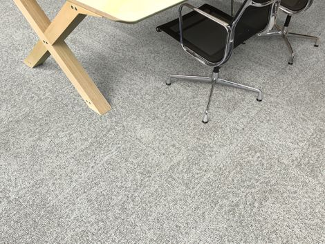 Interface Open Air 405 carpet tile in overhead view with corner of wood table and rolling chair image number 3