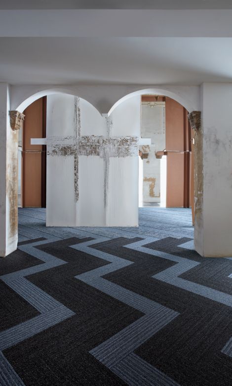 Interface WW865 and WW895 plank carpet tile in lobby setting with archway