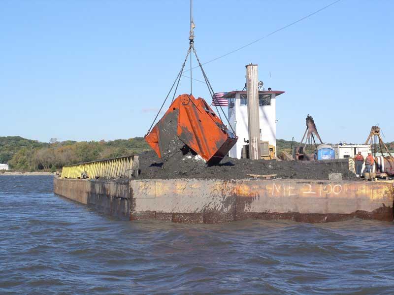 Image of crane on barge dumping sediment