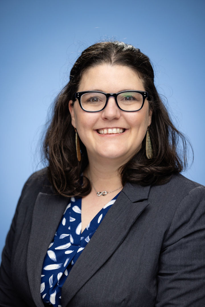 Head shot of woman with dark hair who is smiling 