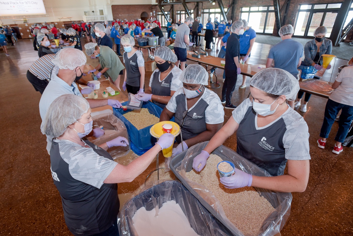 Reliance Steel & Aluminum employees participate in the Meal Pack for 9/11 Day of Service event in the Aon Grand Ballroom at Navy Pier in Chicago, IL on Saturday, Sept. 11, 2021.  Photo by Mark Black