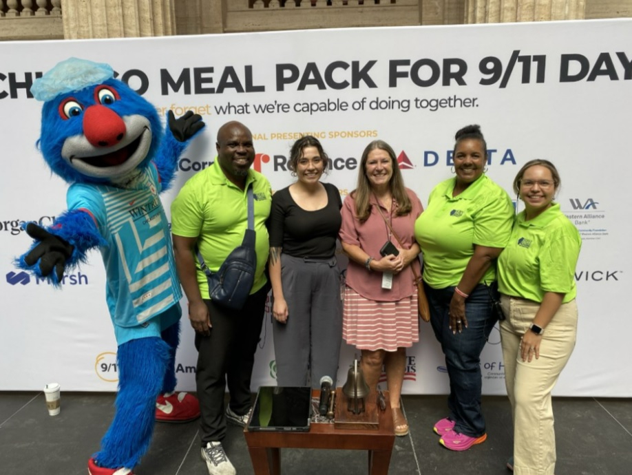 Pictured above left to right: Chicago Red Star’s Soccer Mascot Supernova, Jacob Jenkins IDHS-Serve Illinois Volunteer Program Manager/Disaster Liaison, Jessica Ramos, Assistant Director, Division of Family and Community Services IDHS, Leslie Cully, Interim Director, Division of Family and Community Services IDHS, Davida Fanniel IDHS-Serve Illinois National Service Program Manager, and Cecilia Maciel Martinez IDHS-Serve Illinois Upstate Volunteer Programs Coordinator.