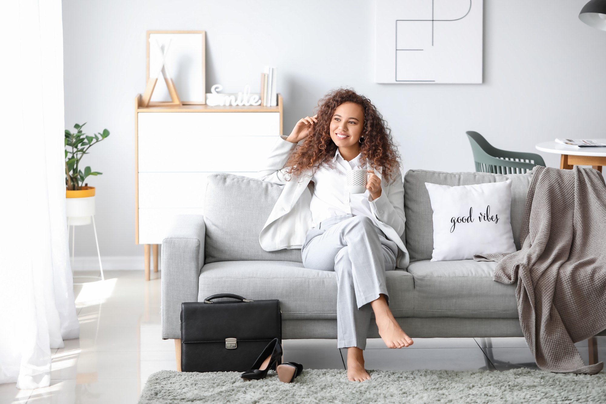 Businesswoman relaxing on sofa after work at home