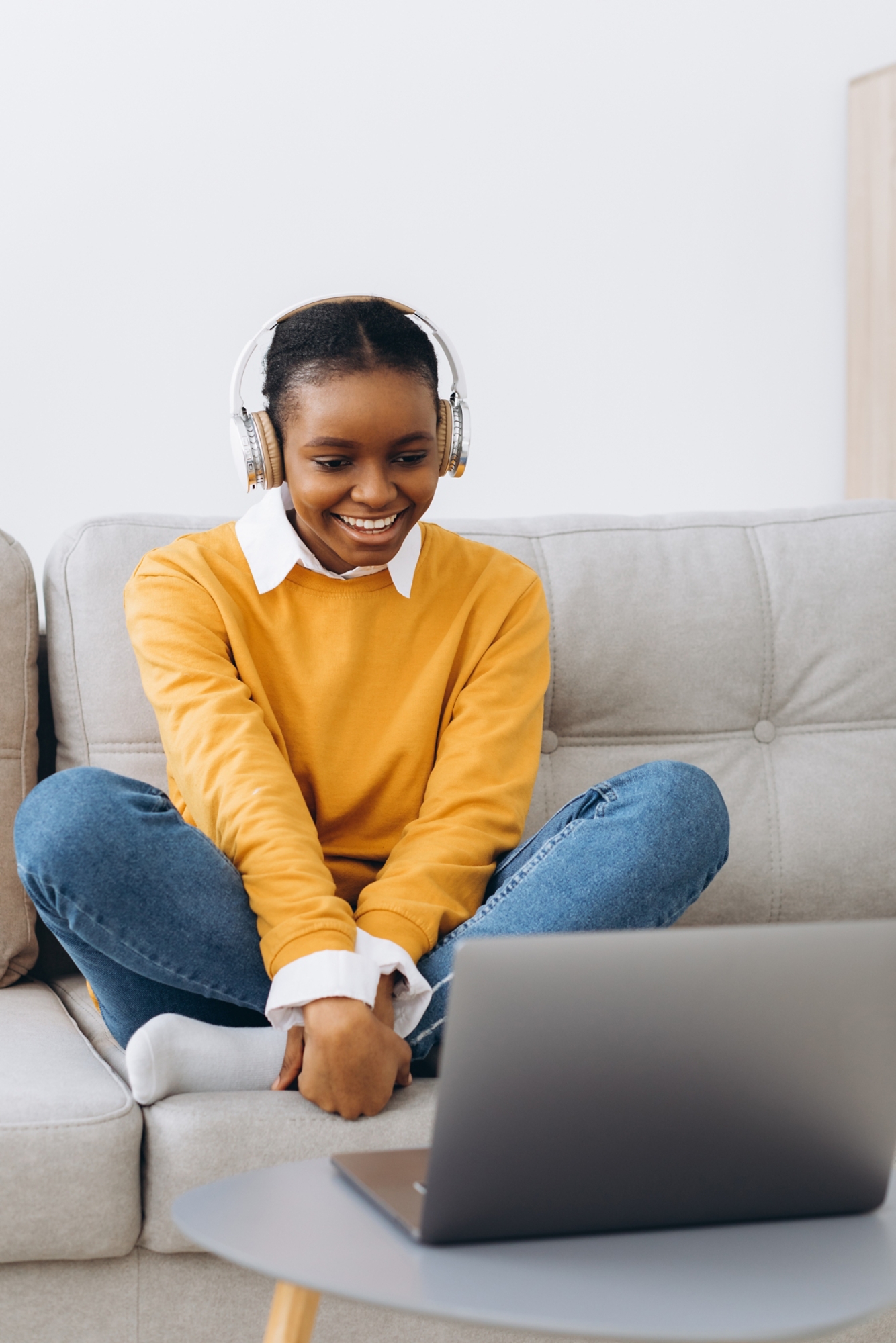 Young African American woman talking on video call in living room at home, distance learning concept from home.