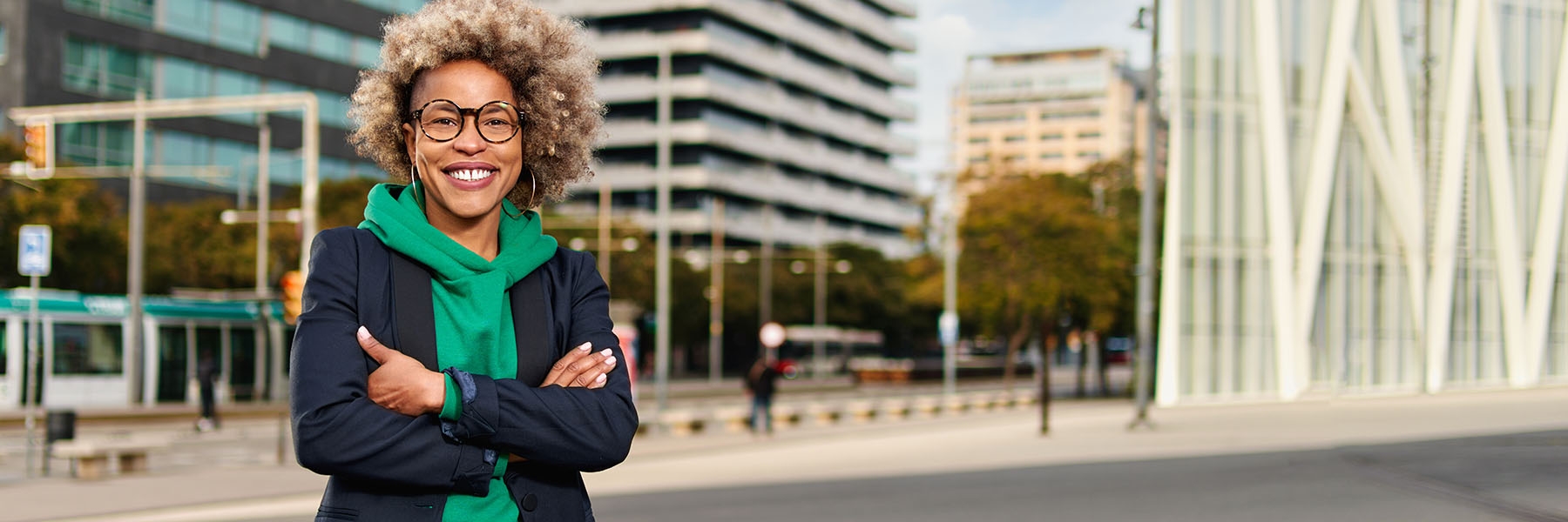 Happy professional posing near office building. Young African American business woman. Female business leader concept