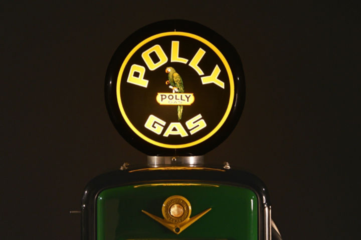 Globe on top of a Polly Gas fuel pump with a green parrot in the center.