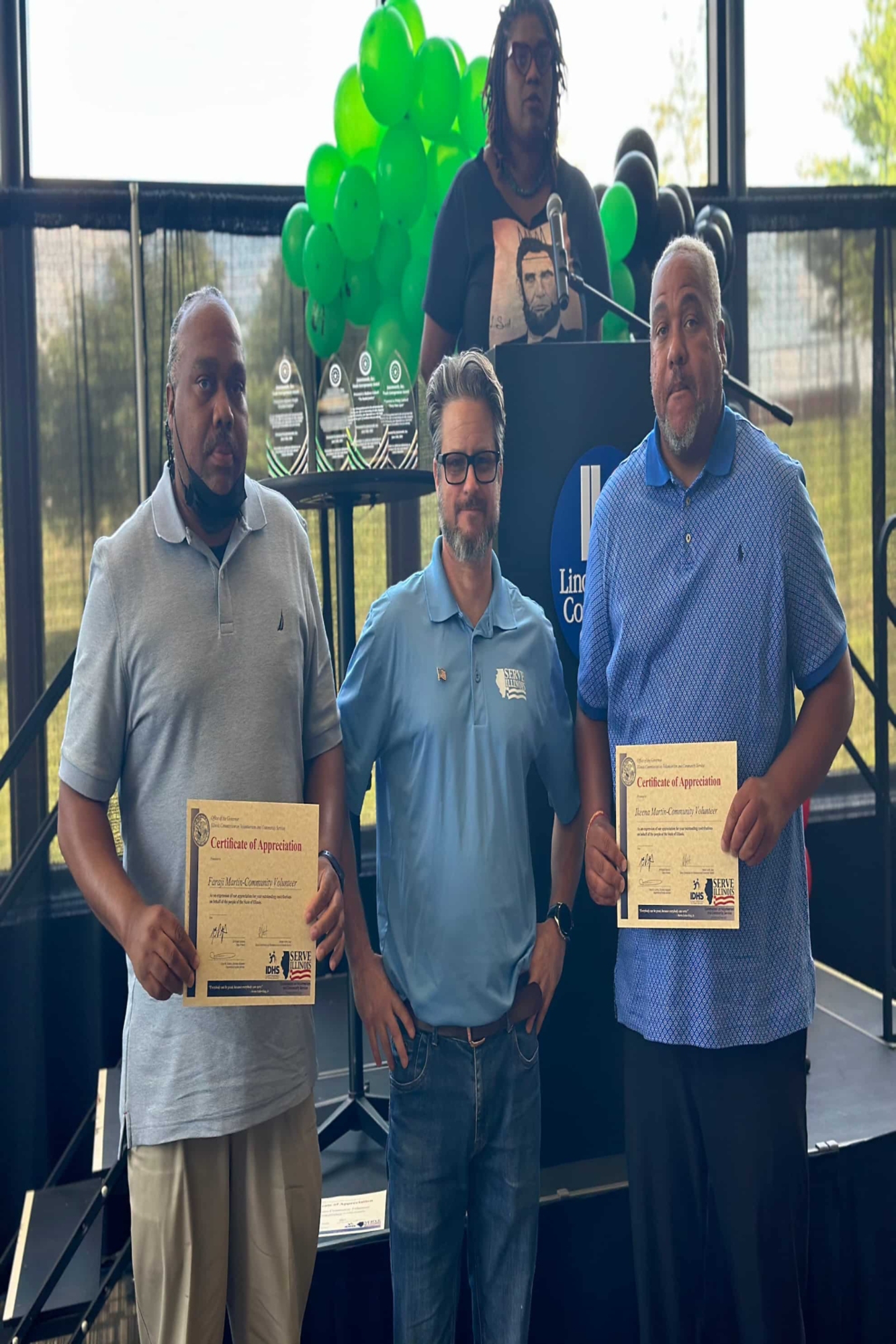 From left to right: Faraji Martin holding Governor's Certificate of Appreciation, Serve Illinois Volunteer Service Program Coordinator Anthony Wanless and Ikeena Martin holding Governor's Certificate of Appreciation 