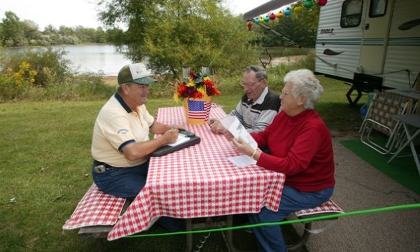 Campground Host at a picnic table with campers