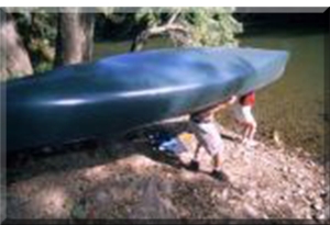 Portafing a canoe into the river