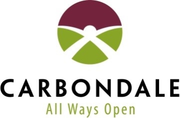 The logo for the city of Carbondale, Illinois, with the outline of a sun rising against a red sky over an intersection.