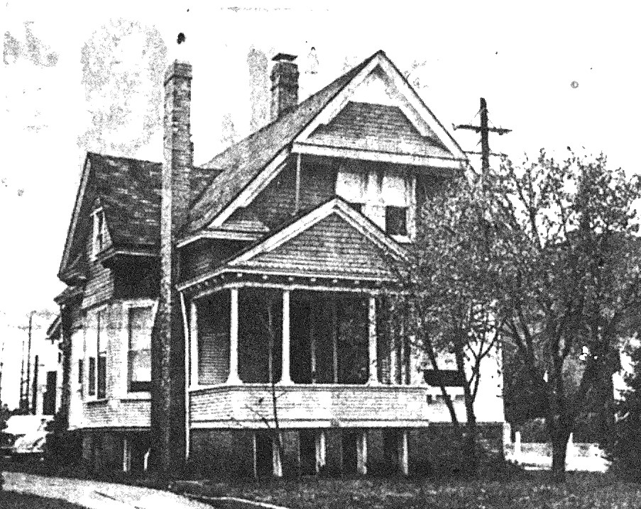 A late nineteenth century 2-story house with a covered porch and two chimneys