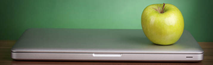 Laptop and green apple