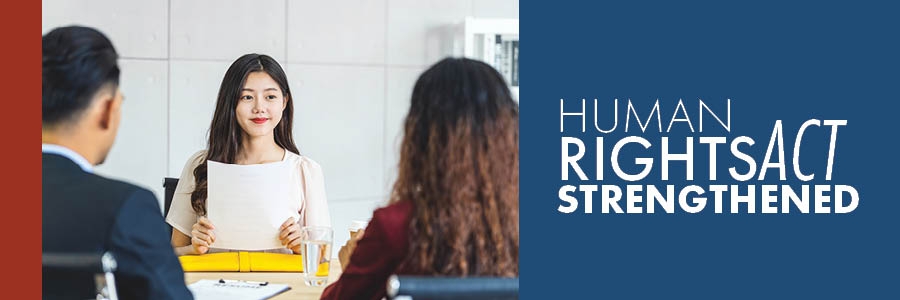 Image of worker in an office, with text, "Human Rights Act Strengthened"
