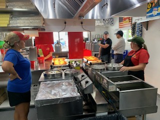 Image #2: Illinois Department of Public Health Director Dr. Sameer Vohra accompanies a worker from the Sangamon County Department of Public Health during a food vendor inspection at the Illinois State Fairgrounds.