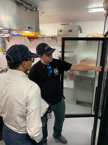 Image #1: Illinois Department of Public Health Director Dr. Sameer Vohra accompanies a worker from the Sangamon County Department of Public Health during a food vendor inspection at the Illinois State Fairgrounds.