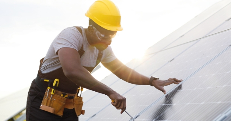 Man working on solar panel
