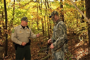 Conservation Officer checking hunting license