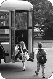 children getting on bus