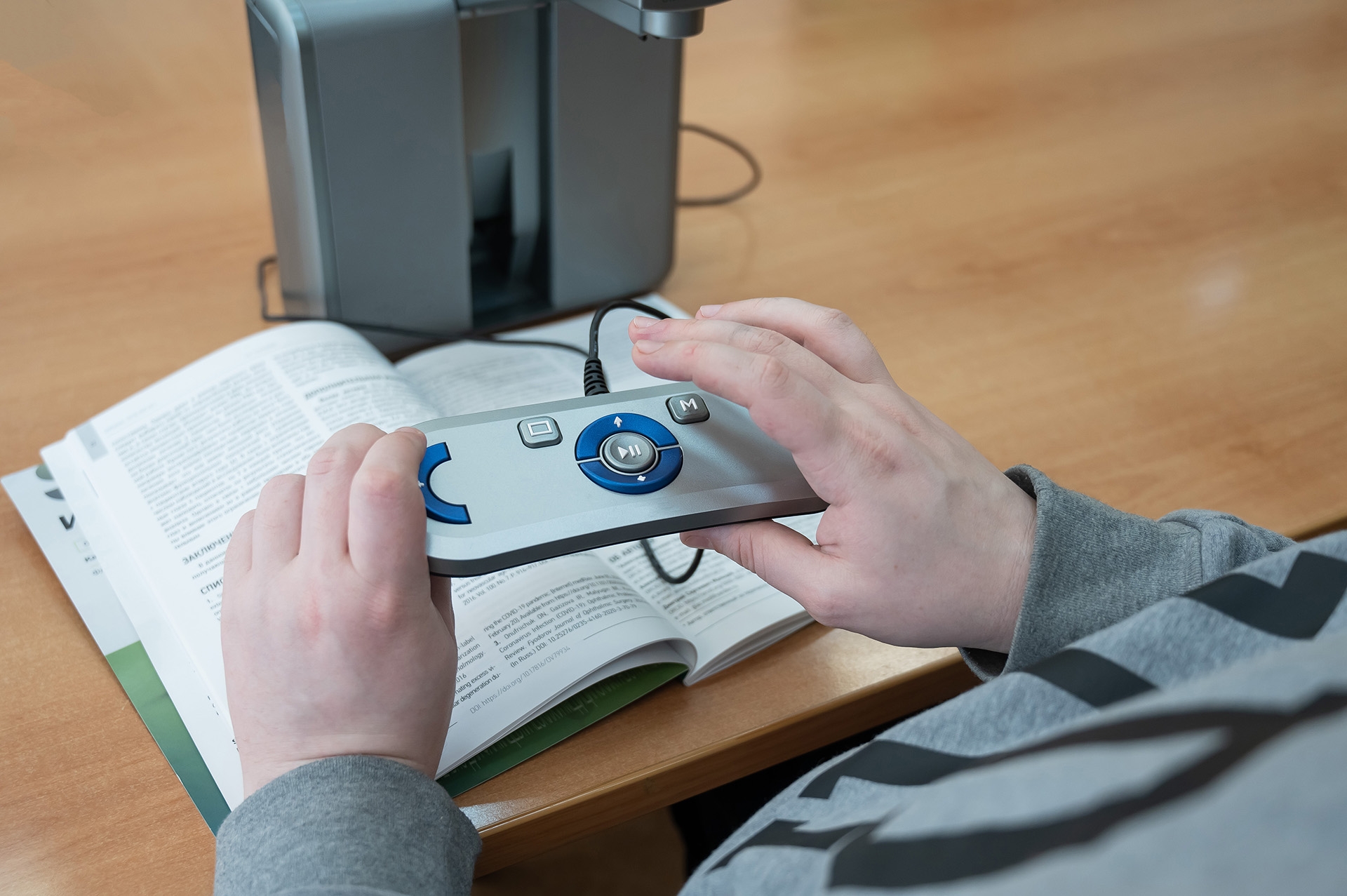 A visually impaired man uses a scanning and reading machine