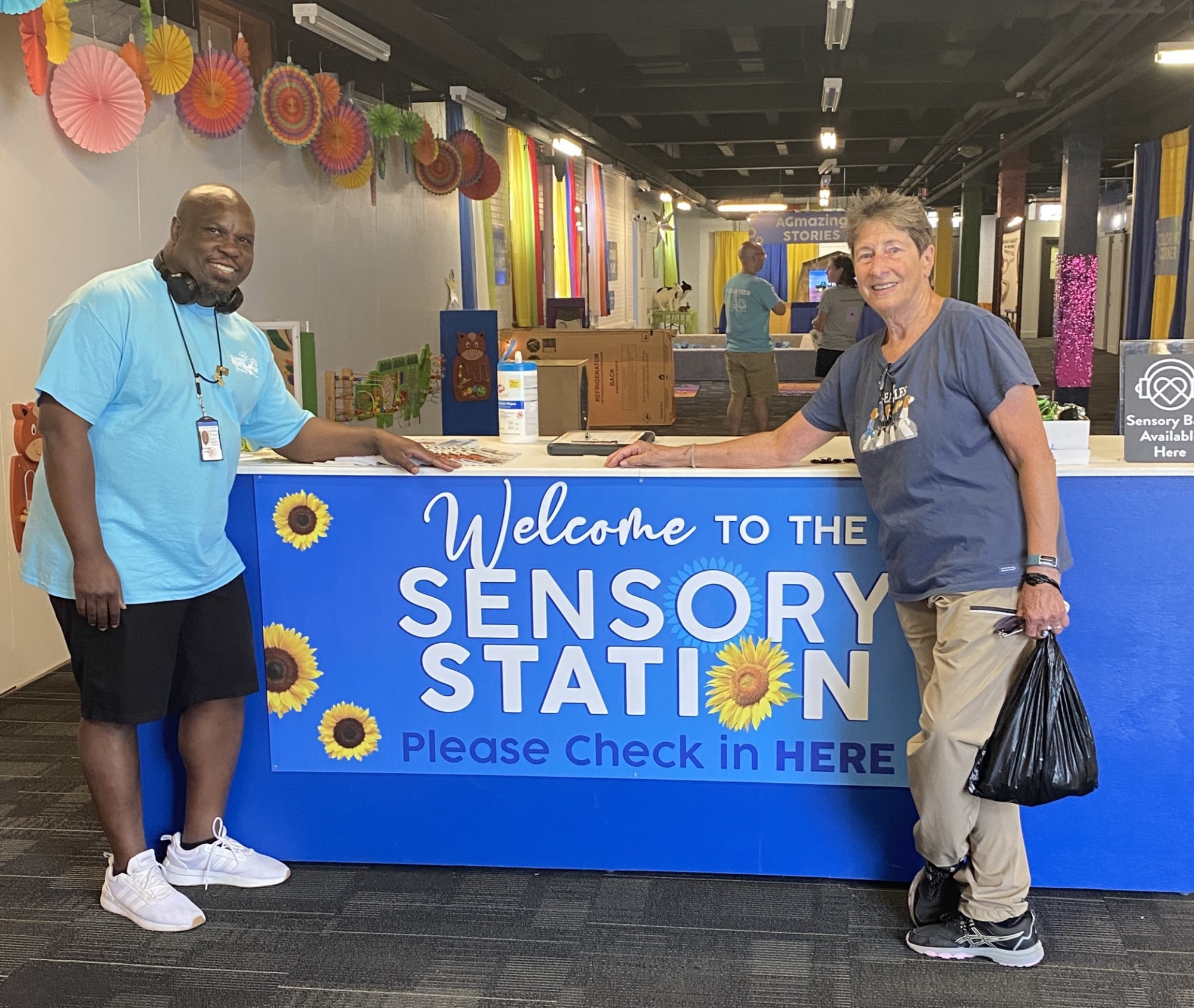 staff in front of sensory station sign