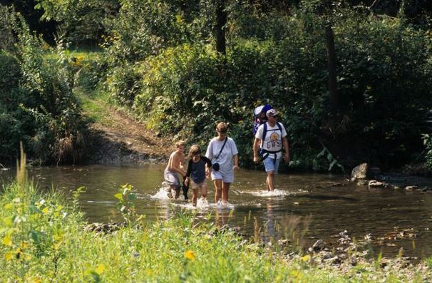 Family crossing a stream