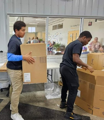 Volunteers moving boxes