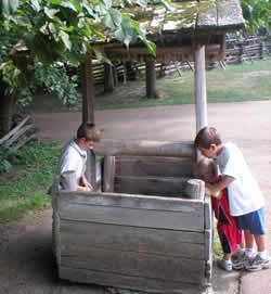 Photo: Two boys investigating old wooden well