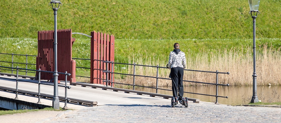 Young woman riding segway in the park