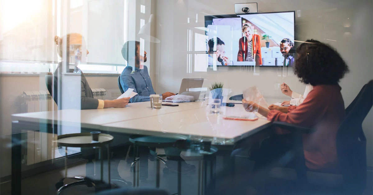 Group of young business people discussing with colleagues on video conference on meeting