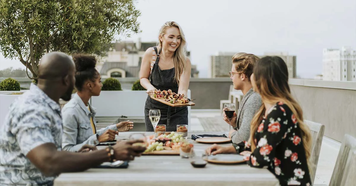 Group of colleges having lunch and drinks at a restaurant