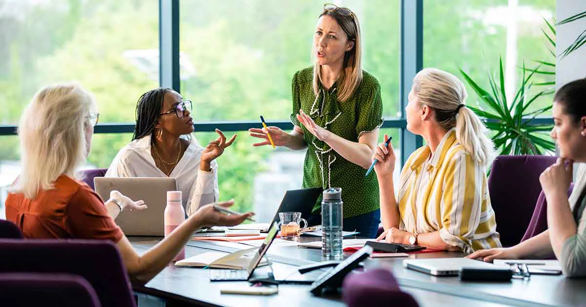 Team gathered around table discussing business opportunity