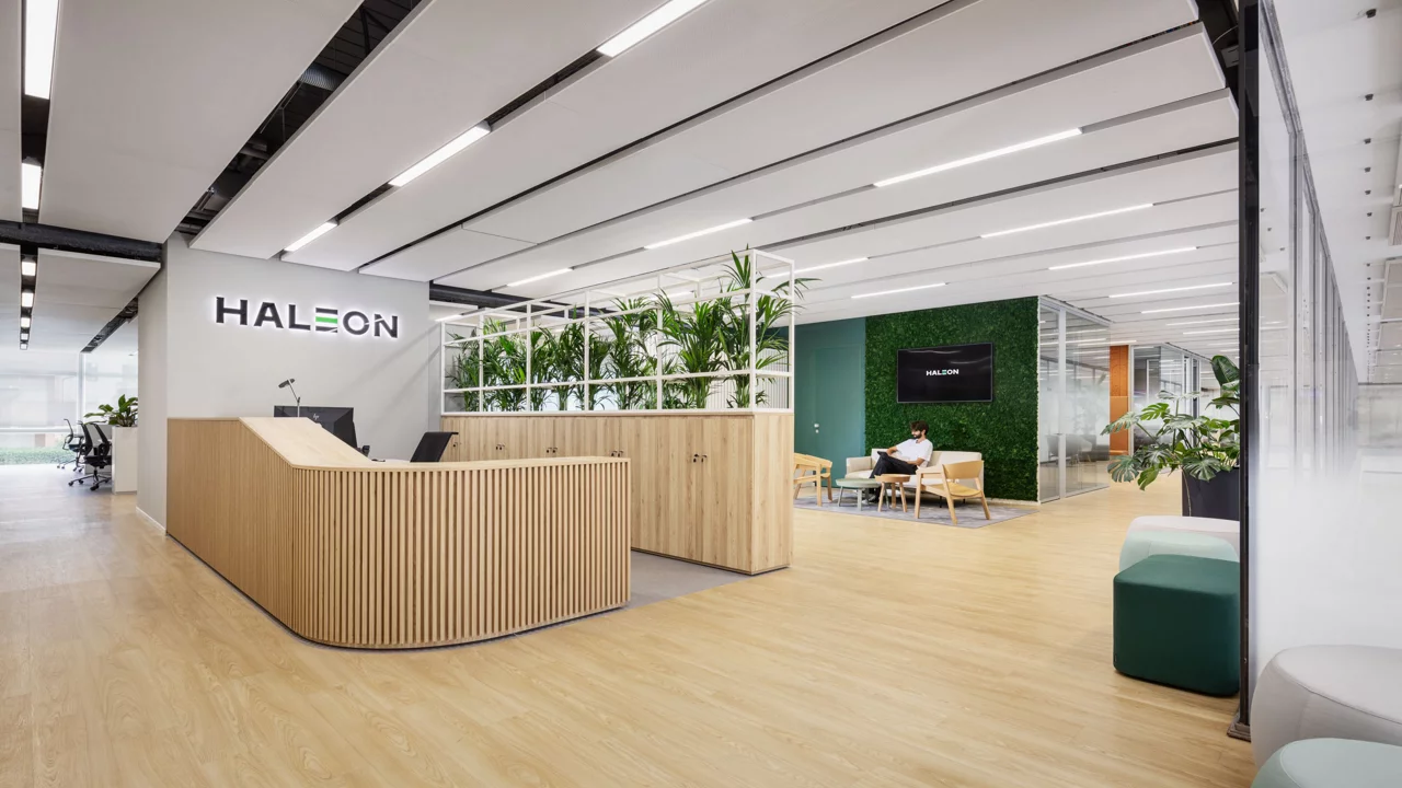 Haleon reception area with greenery where a guy is sitting on sofa