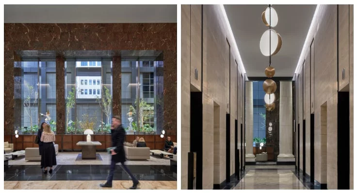 Spacious, modern office lobby with tall marble columns and polished stone floors.