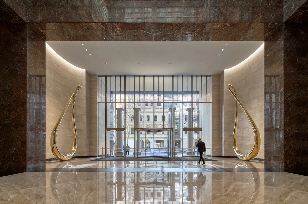 The lobby features large gold sculptures, creating an elegant and luxurious atmosphere for visitors.