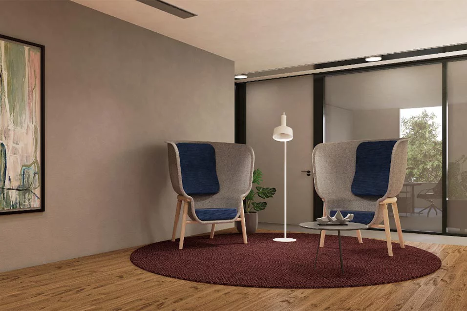 A stylish living room showcasing two chairs and an artistic painting above them.