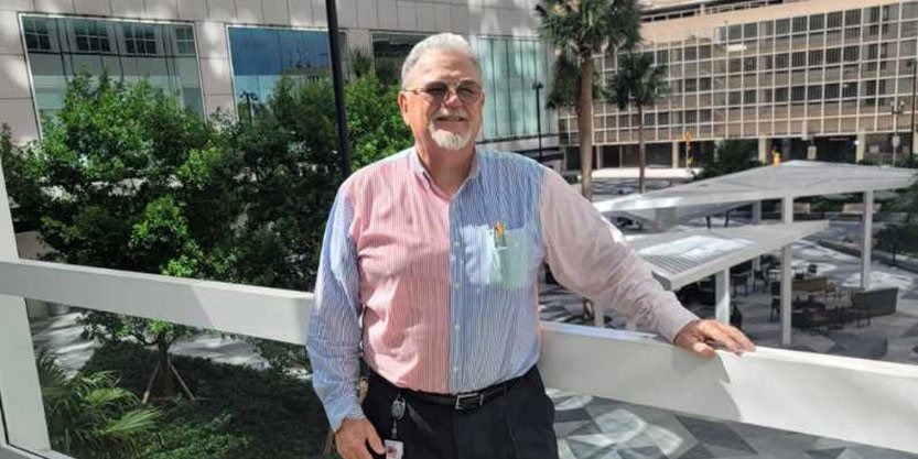 David Siljee standing in front of hotel