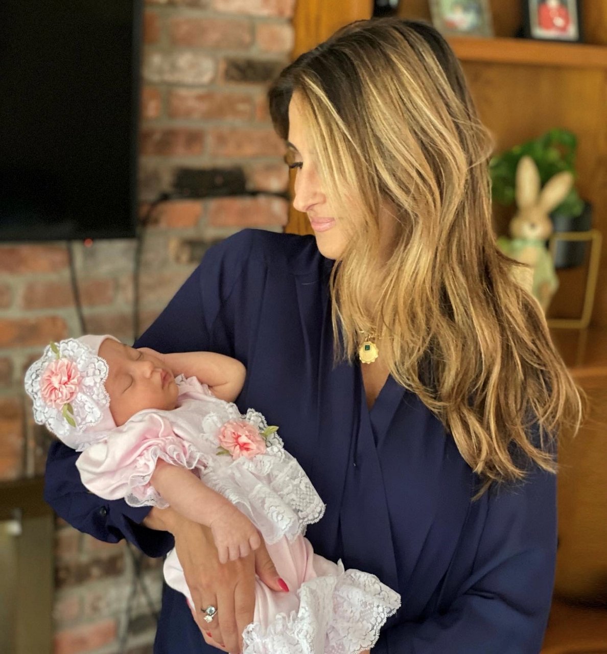 a Caucasian woman holding her baby