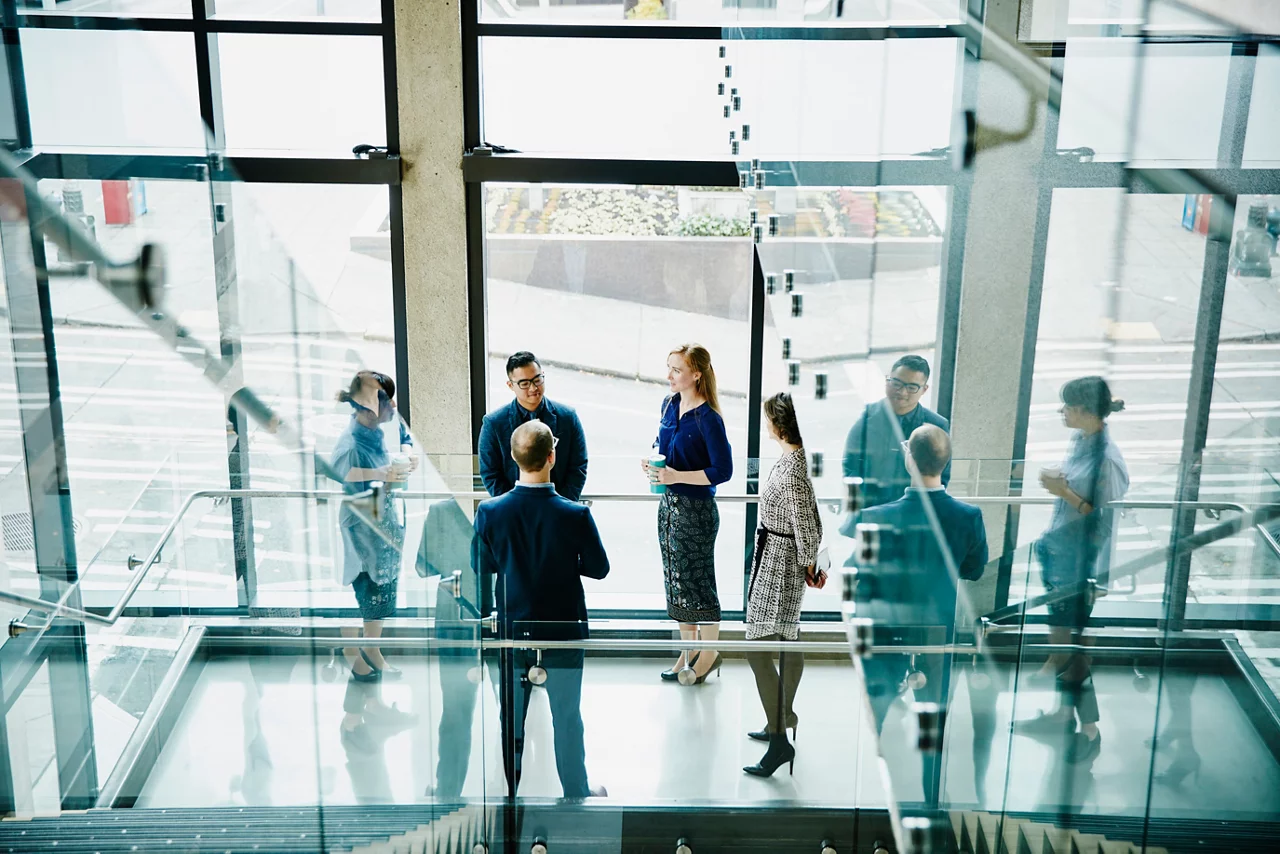 Business colleagues having informal meeting on office stairs