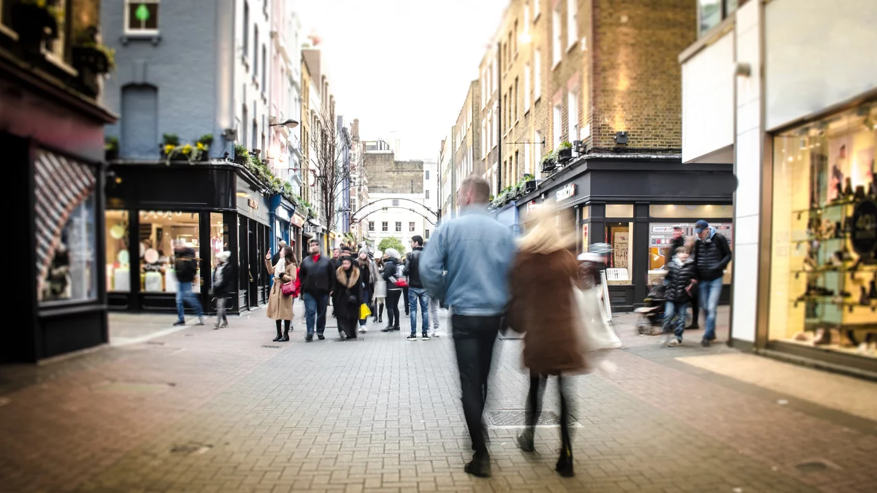 Couple walking on street of urban market
