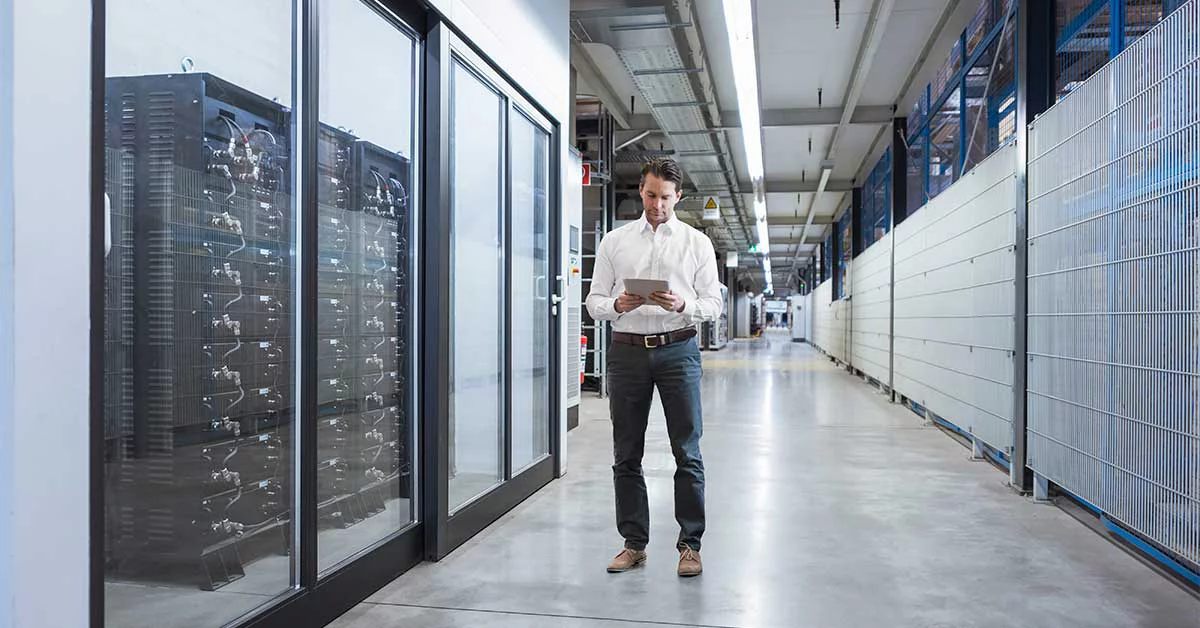 Businessman using tablet in modern data center