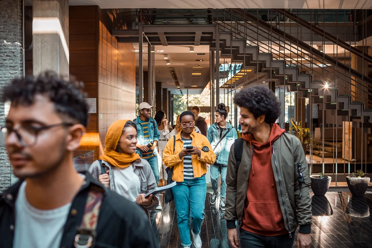 Group of college students entering the university campus