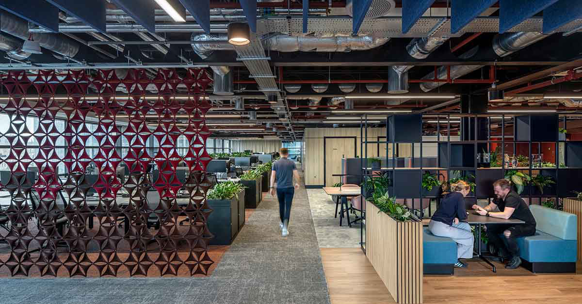 Office worker walking through a large open-plan office